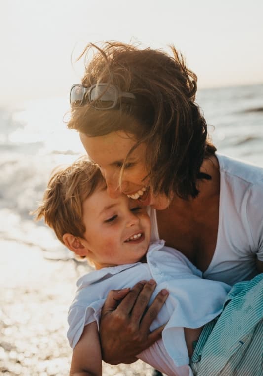 An image with woman hugging child